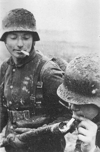 Badass German soldier lighting his cigarette with a flamethrower somewhere on the eastern front.