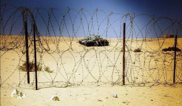 An abandoned Israeli tank is seen behind barbed wire at an open section of Bar Lev Line in Sinai Peninsula, Egypt
