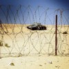 An abandoned Israeli tank is seen behind barbed wire at an open section of Bar Lev Line in Sinai Peninsula, Egypt