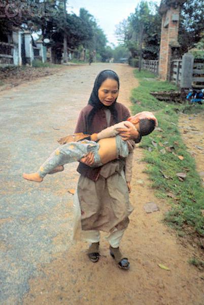 11 Feb 1968, Hue, South Vietnam - Vietnamese Woman Carrying Her Wounded Son