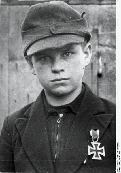 12-year-old Hitler Youth member Alfred Zech from Goldenau, Germany, with his Iron Cross 2nd Class medal, March 1945