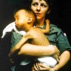 Nurse caring for a sick Vietnamese child at a MUST field hospital