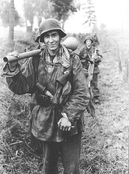 Heavily armed soldier of the Pz Div Hermann Göring smiling to the camera, Russia, 1944