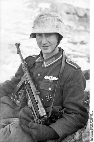 A young German soldier with an MP40 in the Russian winter snow