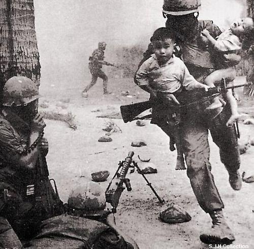 A soldier rescuing Vietnamese children