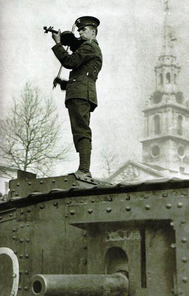 Soldier playing the violin on a tank. WWI