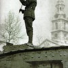 Soldier playing the violin on a tank. WWI