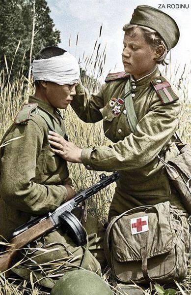 Wounded Russian, child soldier, is patched up by a child medic in the field