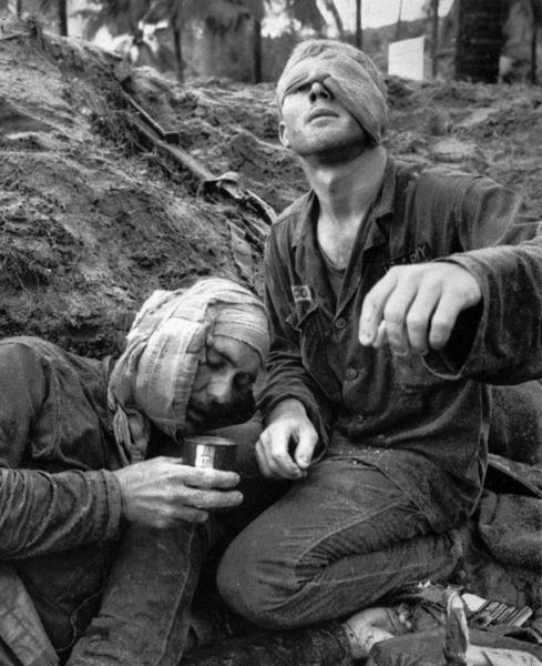 Helicopter crew chief James C. Farley shouts to his crew while wounded pilot Lt. James E. Magel lies dying beside him, Vietnam March 31, 1965.