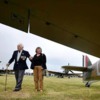 Battle of Britain veteran pilot Tony Pickering and his wife, Chris, walk between a Spitfire (L) and Hurricane aircraft