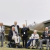 Veterans gather by a hurricane plane at the commemoration