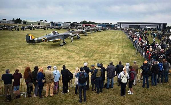 Crowds gather to see Hurricane and Spitfire planes before they participate in a flypast over Biggin Hill airfield in Kent