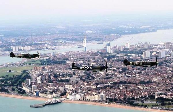 Two Spitfires and a Seafire during a formation flight over Portsmouth to commemorate the 75th anniversary
