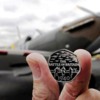 The Royal Mint’s Battle of Britain 50p commemorative coin, with a Mark I Spitfire that took part in the conflict being displayed at Humberside airport in Lincolnshire