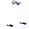 An Airbus A380 passes overhead as Spitfires and Hurricanes take to the skies