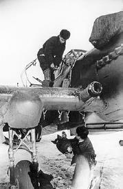 An armourer loading a bomb into one of the wing root bomb bays of an Il-2