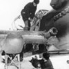 An armourer loading a bomb into one of the wing root bomb bays of an Il-2